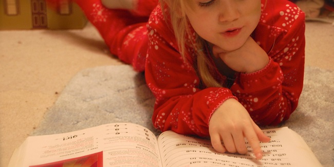 Little girl reading book 